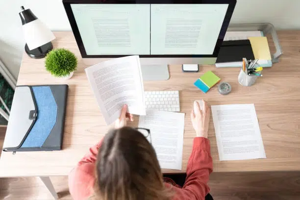 person reading content in front of computer -copywriting services