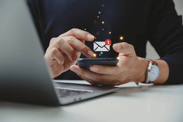 Person using a smartphone with an email notification alert. -shareable links in email marketing