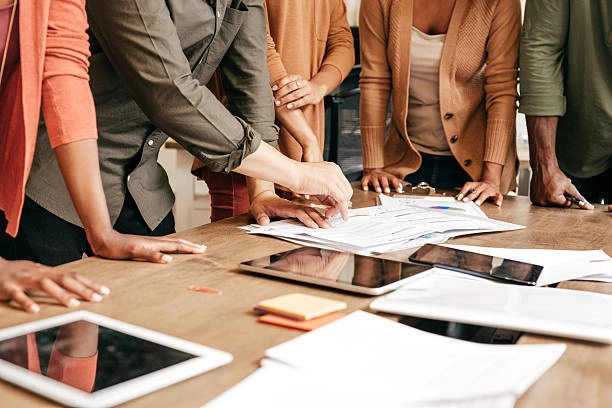 Team members gather to review and discuss important project documents. -best digital marketing companies