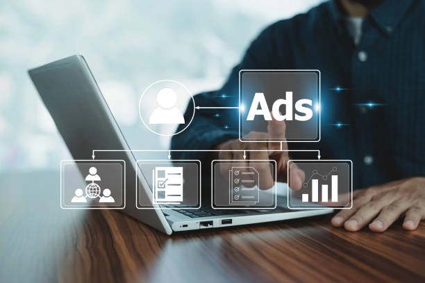 Person using laptop with digital ads, analytics, and marketing icons. -google ads management company